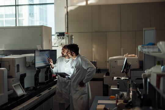 Research team working on screen in medical laboratory
