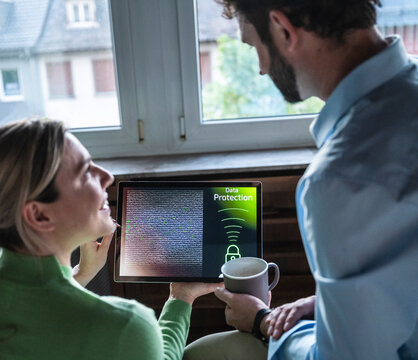 Business team discussing data protection on tablet in office
