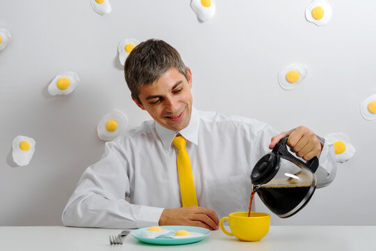 Office worker enjoying surreal breakfast with fried egg motif and coffee