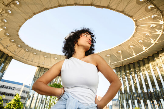 Model posing under modern architectural structure