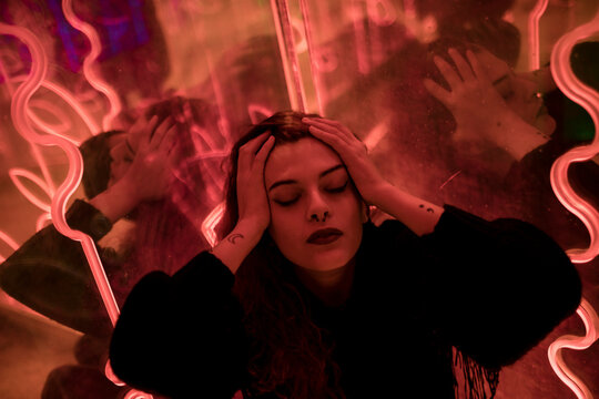 Overwhelmed by emotional tension and stress with hands on head