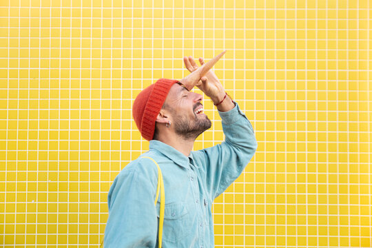 Playful unicorn pose with ice cream cone against yellow wall