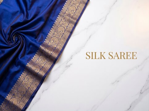 Royal blue silk saree with golden zari border, elegant Indian traditional ethnic wear on white marble background, luxury textile for wedding fashion