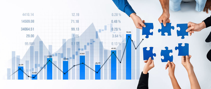 Hands holding puzzle pieces above a financial growth chart symbolize collaboration in business strategy. Ideal for themes of teamwork, innovation, and planning. Scalp