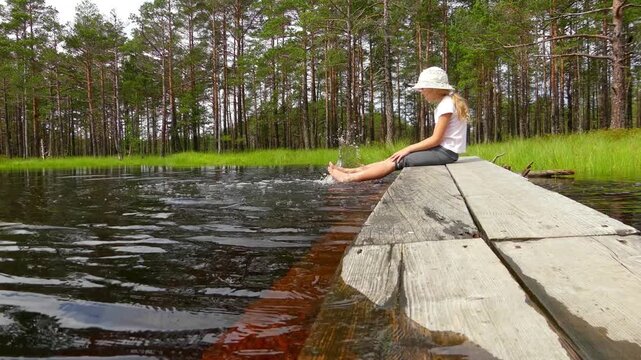 Little girl walks on Swamp Viru Raba in Estonia