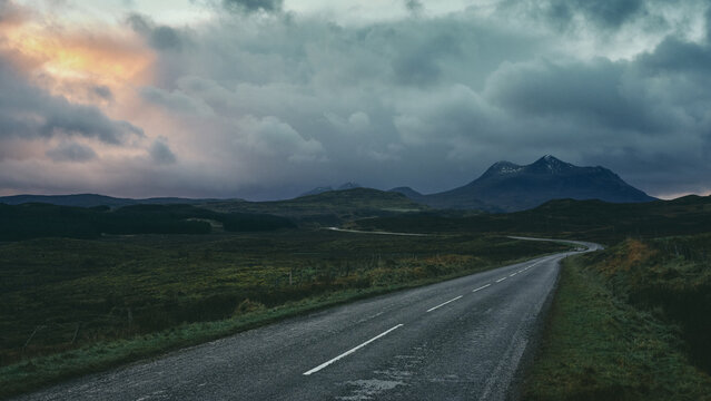 empty road in the mountains at sunset