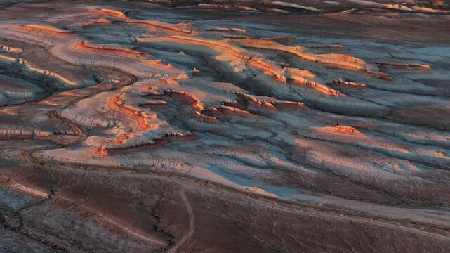 Aerial view of the layered Kyzyl Kup Tiramisu mountains with colorful rock formations and desert terrain in Karakiya District, Mangystau Region, Kazakhstan.