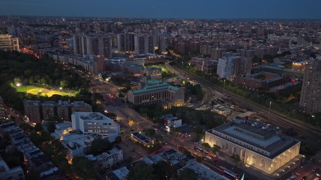 Bronx County Courthouse and Grand Concourse in South Bronx, New York City, during early evening twilight with city lights illuminating streets and buildings