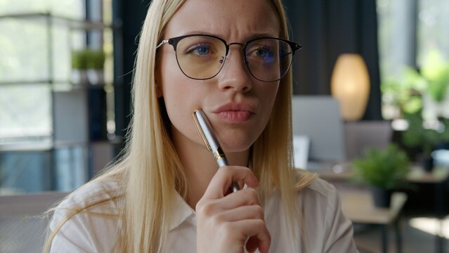 Close up concentrating clever Caucasian business woman thinking student girl think difficult homework task work plan businesswoman holding pen deep in thoughts expression female company boss in office
