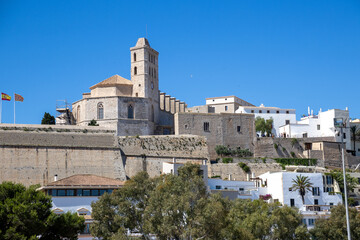 Obraz premium «Ibiza, Spain»; May 26 2026: View from Baluarte de Santa Lucia ancient fortress wall over the historic white houses and traditional buildings of Dalt Vila old town, a UNESCO World Heritage site