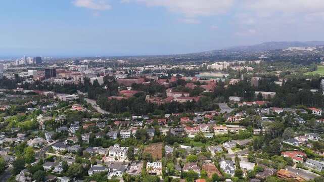 Prestigious Westwood neighborhood in Los Angeles with UCLA campus, Bel Air mansions and wealthy residential properties with swimming pool under blue sky