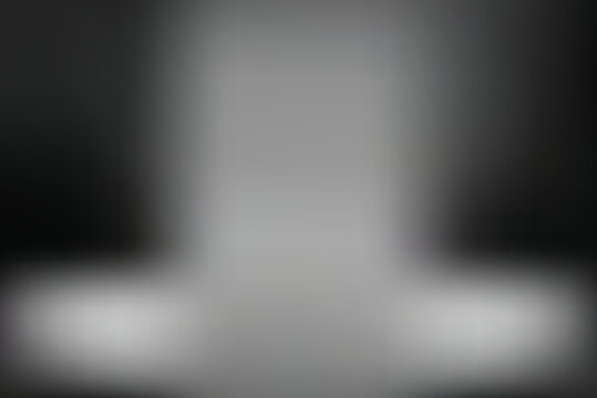A gray blurry object sits on a surface against a dark transparent background