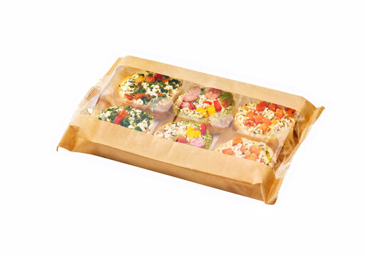 Bruschetta on Toasted Baguettes on a tray in plastic wrap isolated on white