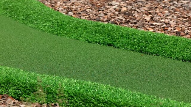 Miniature golf course. Artificial turf border next to ground cover