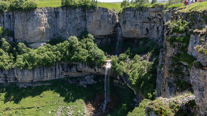 Fototapeta premium Scenic view of Matlas Waterfalls dropping into a deep limestone canyon near Matlas village, Khunzakhsky District, Republic of Dagestan, Russia on a sunny day