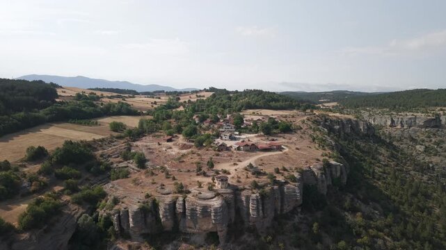4K 10-bit drone pull-back shot flying backward from the Terrace observatory and village over Tokatli Canyon in Safranbolu, Turkey