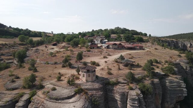 4K 10-bit low flying drone shot forward past the Crystal Glass Terrace observatory and remote village over Tokatli Canyon in Safranbolu, Turkey