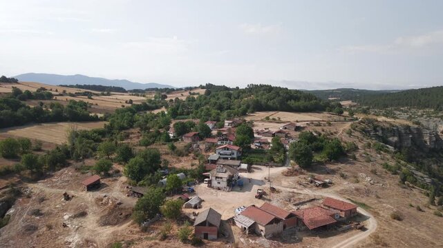 4K 10-bit drone pull-back shot flying backward from the Crystal Glass Terrace observatory and village over Tokatli Canyon in Safranbolu, Turkey