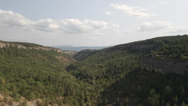 4K 10-bit drone pull-back shot flying backward over the deep rocky valley of Tokatli Canyon in Safranbolu, Turkey