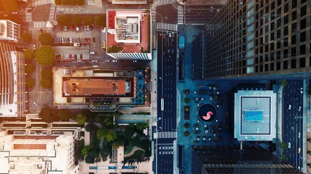 Aerial perspective shows traffic congestion in downtown Los Angeles during rush hour. Skyscrapers and city streets define the landscape with visible commuter activity.
