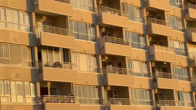 An Apartment block with the late afternoon sun on it.
