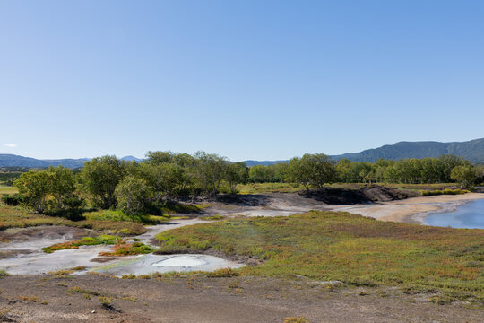 Wide view of the Uzon Volcano caldera with geothermal hot springs, mineral pools, tundra vegetation and distant mountains, Kronotsky Reserve, Kamchatka Krai, Russia