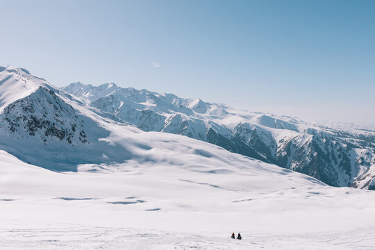 Wide scenic view of snow-covered mountain ridges and untouched slopes at Karakol ski resort near Karakol, Issyk-Kul Region, Kyrgyzstan on a clear sunny day