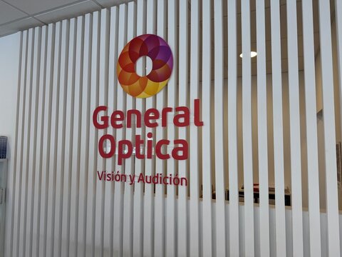Palma, spain, june 2, 2026, general optica brand logo sign with identity elements on interior slatted wall at an eye care center