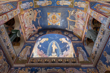 Fototapeta premium Bar, Montenegro - August 10, 2025: Wide view of Orthodox Christian frescoes and iconography covering the arched ceiling inside the Church of St. Jovan Vladimir in Bar, religious art and architecture