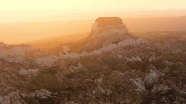 Aerial view of the Airakty mountains with rocky peaks and desert landscape during golden hour in Shetpe, Mangystau Region, Kazakhstan.