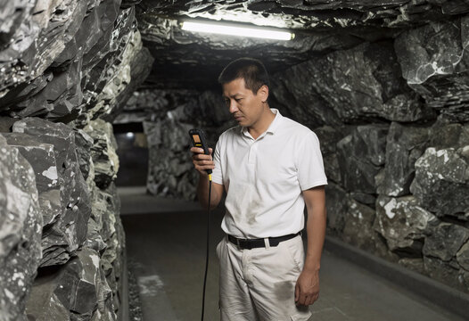 Uranium Miner Measuring Radiation with Geiger Counter