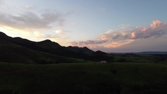 Aerial view of the iconic mountains of Serra da Canastra at sunset, featuring golden-hour light, rolling highlands, dramatic landscapes, vast horizons, and the natural beauty of rural Brazil.