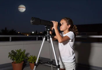 Girl Exploring Jupiter with Telescope on Rooftop © Outsiderzone