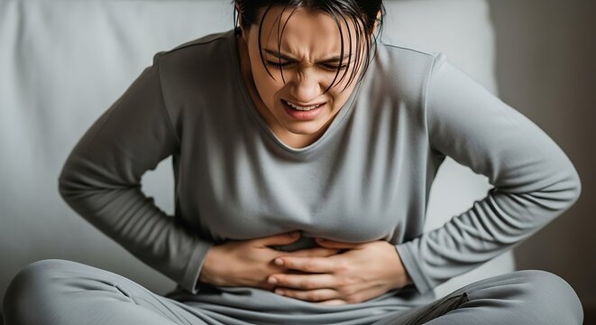 Woman Experiencing Abdominal Pain - A Focus on Digestive Discomfort.