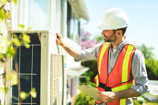 technician working on air conditioning or heat pump outdoor unit inspection or repair