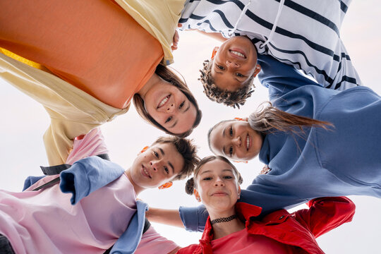 Diverse group of young friends smiling in a huddle