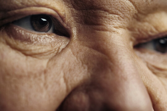 Senior man with wrinkled skin looking away