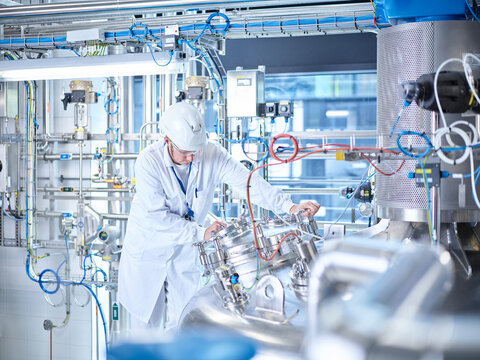 Chemist with helmet in chemical laboratory