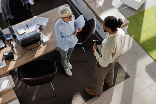 Candidate talking with interviewer standing at office