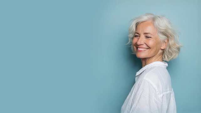 Senior woman smiling isolated on plain background for retirement insurance concept