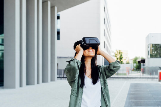 Woman with black hair wearing virtual reality simulator