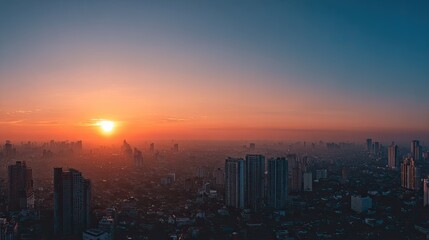 Fototapeta premium Panoramic cityscape at sunrise with warm orange glow illuminating buildings