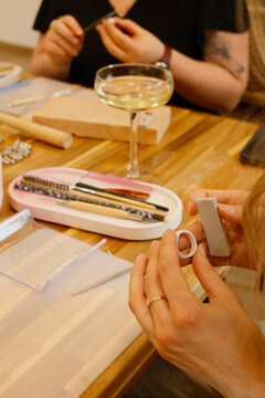 Silver clay ring shaping at workshop with champagne coupe glass, bridal activities, jewelry class