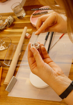 Overhead view of hands detailing silver clay ring at jewelry workshop, jewellery class