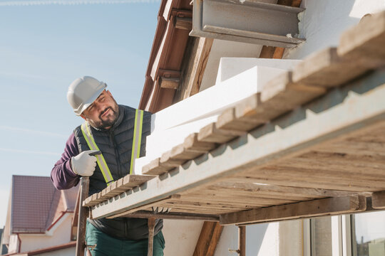 Construction worker with polystyrene foam working at site