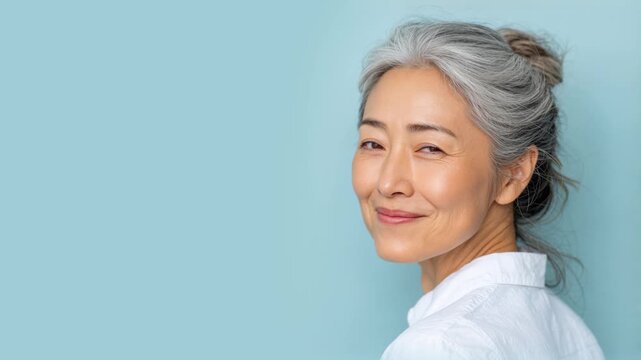 Senior Korean asian woman smiling isolated on plain background for retirement insurance concept