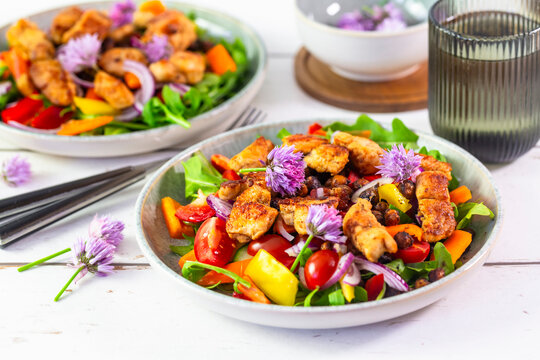 Healthy arugula salad with grilled chicken and roasted chickpeas