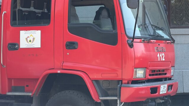 Red Fire Truck Ready for Action: A detailed close-up of a vibrant red fire truck, showcasing its sturdy build and readiness to respond to emergencies. Armenia, Yerevan