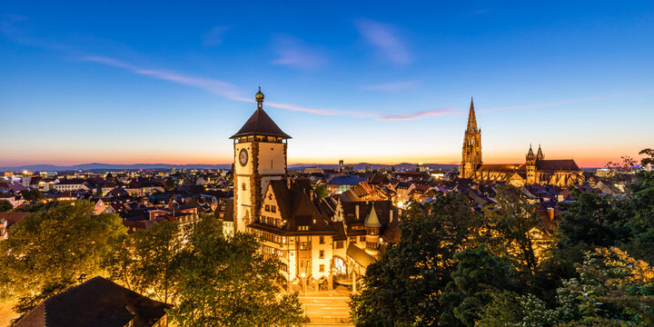 Germany, Baden-Wurttemberg, Freiburg im Breisgau, Panorama of illuminated Schwabentor gate at dusk