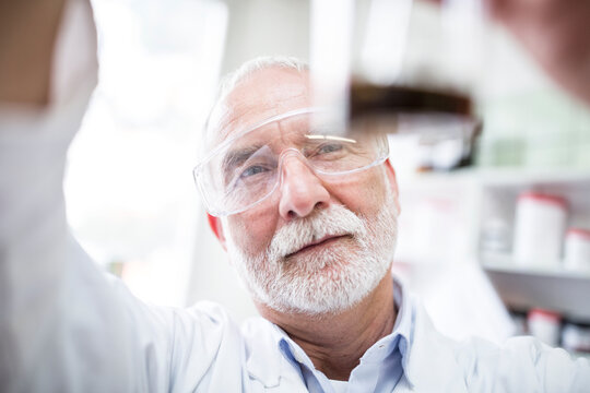Man looking at beaker in laboratory